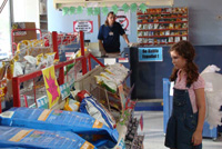 Young girl wearing angel wings shops in a convenience store